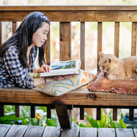 student with cat on bench